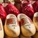 Painted wood clogs featuring different designs and price stickers
